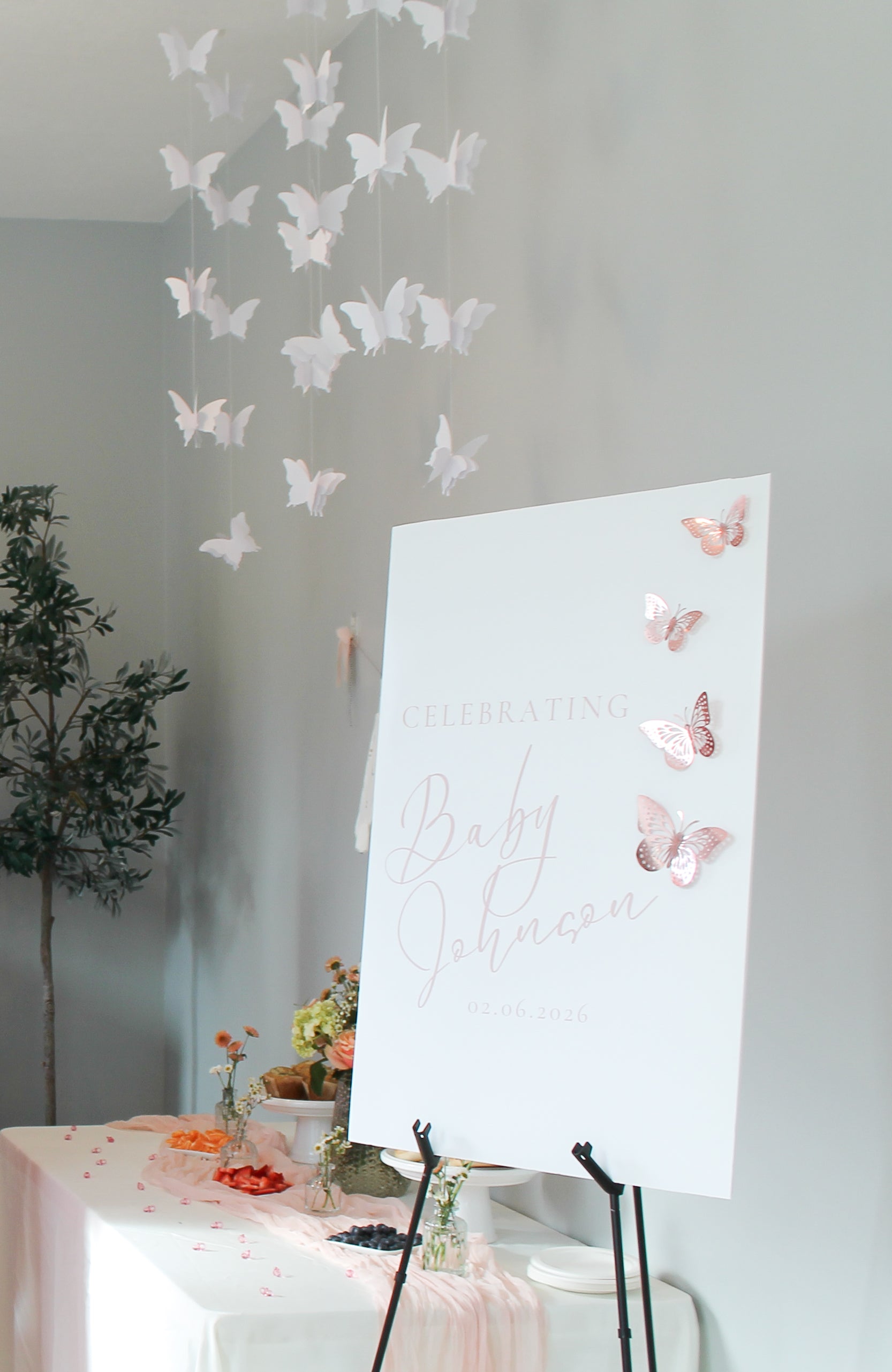 Butterfly decorations on a wall with a welcome sign.